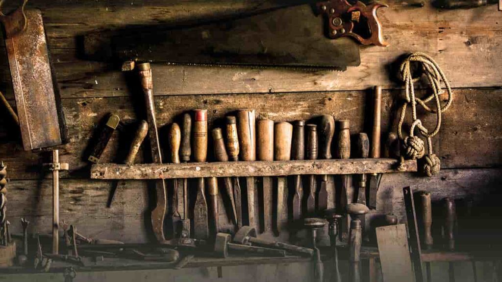 A collection of woodworking tools arranged on a wall representing hard skills